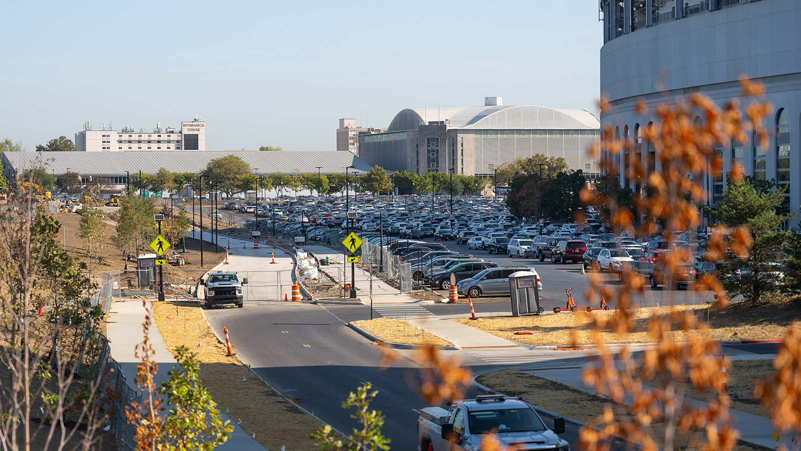 The completed Cannon Drive next to a full parking lot next to Ohio Stadium