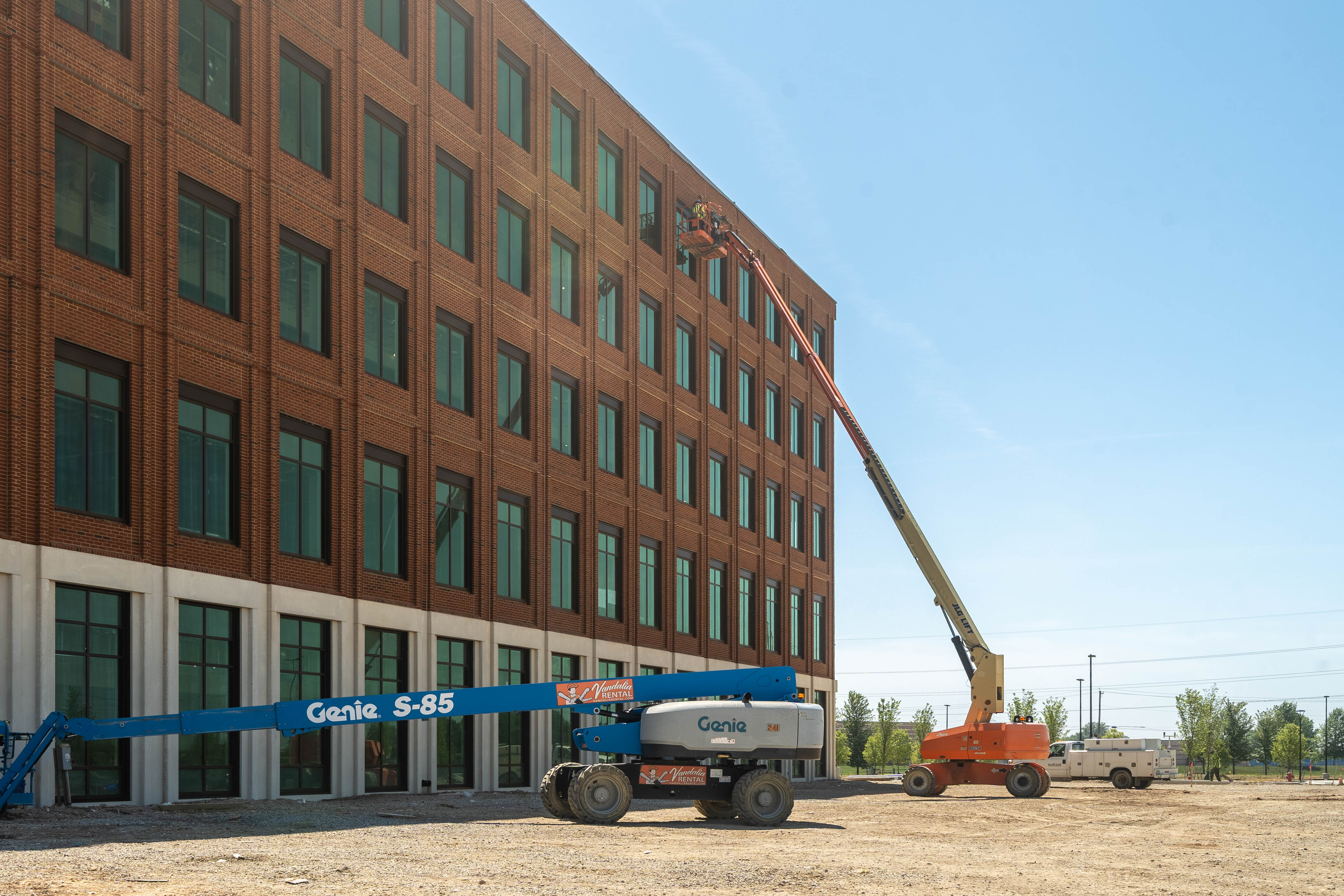 Crews are seen working on the exterior of the brick building.