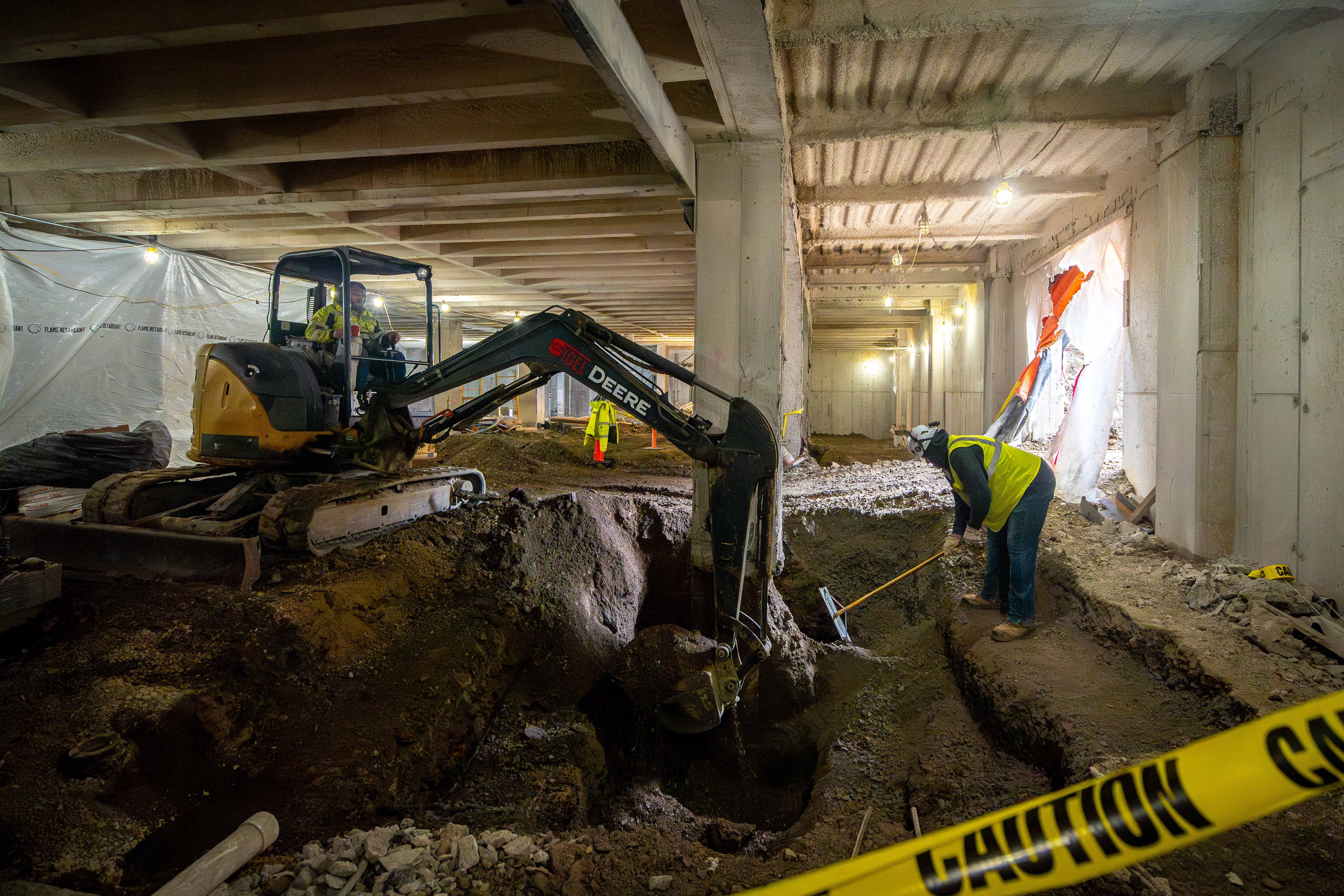 Crews digging a large hole.