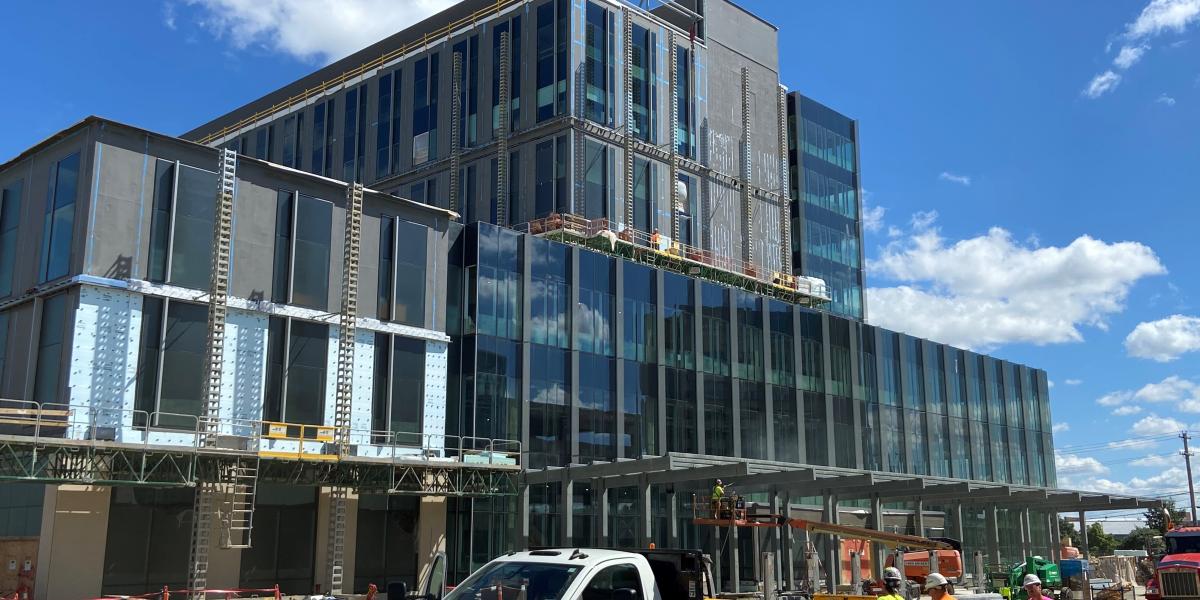 A view of brick and glass building under construction during daytime