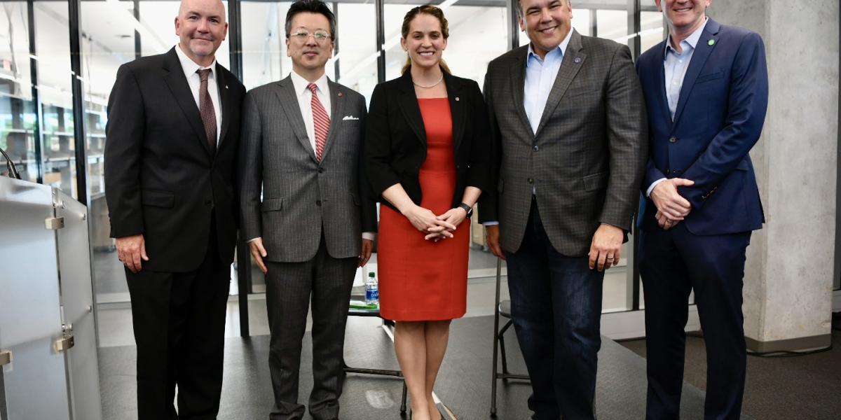Leaders pose inside new building