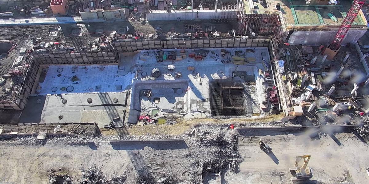Elevator pits are formed and structural columns are constructed.
