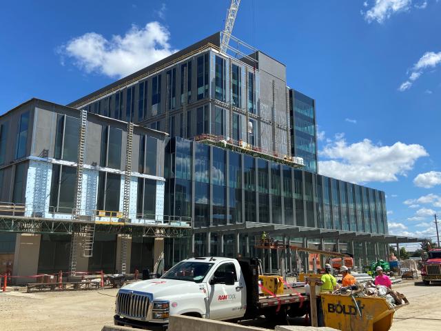 A view of brick and glass building under construction during daytime