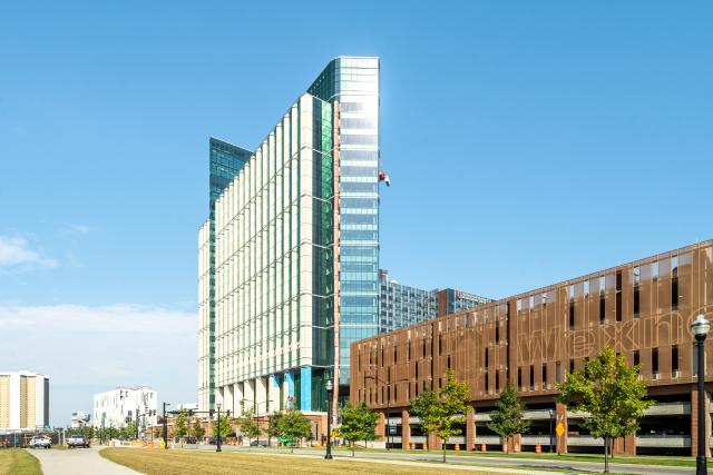 An exterior view of the inpatient hospital with the parking garage in sight on the right.