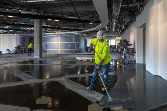 A view of a worker installing flooring.