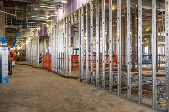 A view of the inside of the building on the second level where crews are installing framing.