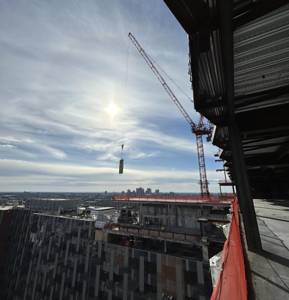 Panel being held in the sky by the crane.