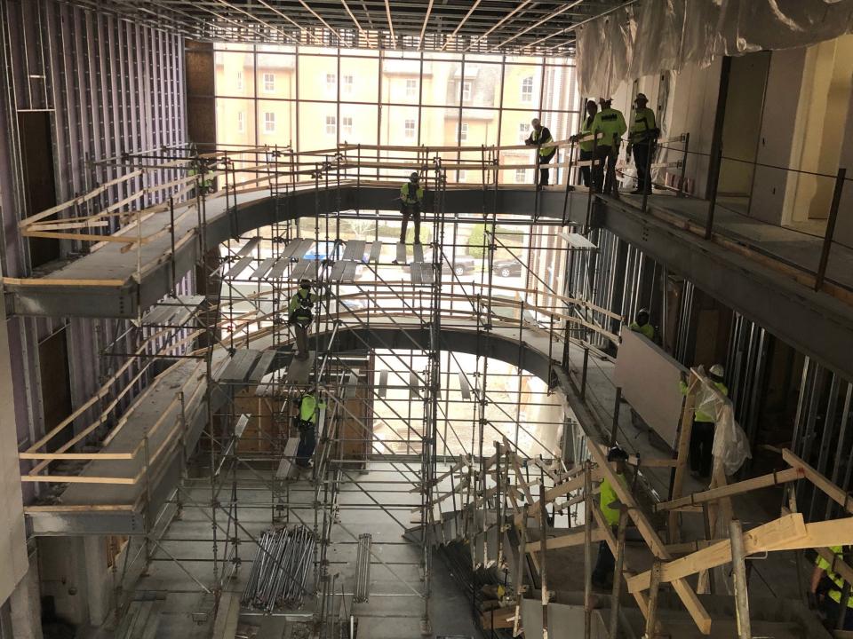 Inside the three-story glass atrium, construction continues on the staircase and elliptical ramps that will connect Heminger Hall and Newton Hall.