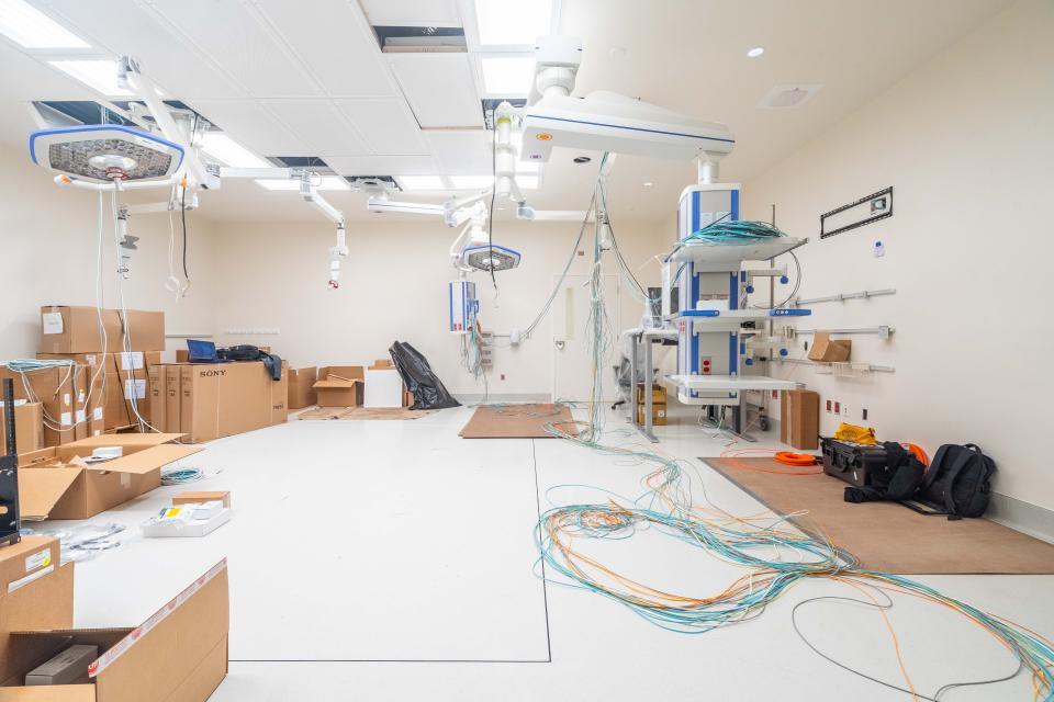 Cables are seen being installed in an operating room.