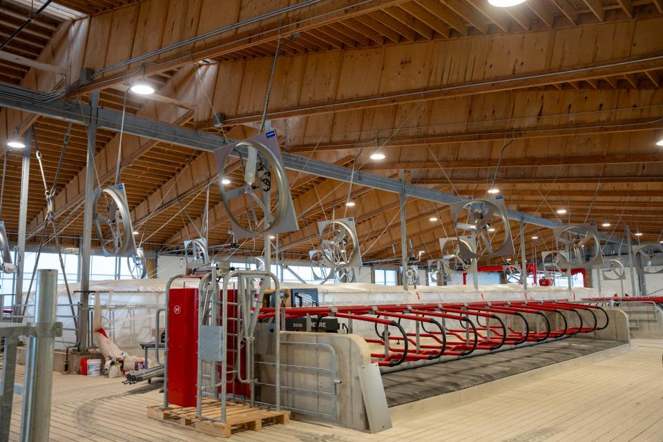 A view of the dairy barn where cattle stalls are seen.